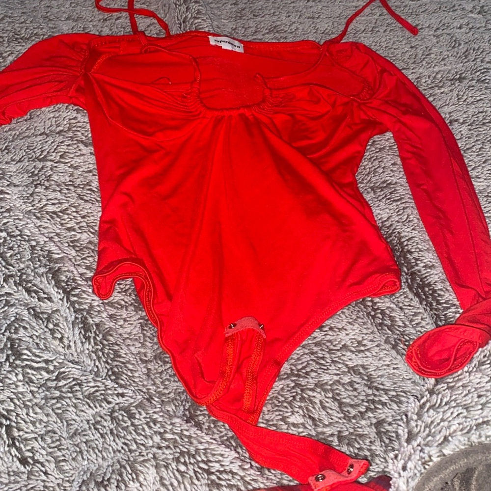Red bodysuit that stretchy it also ties around the neck.